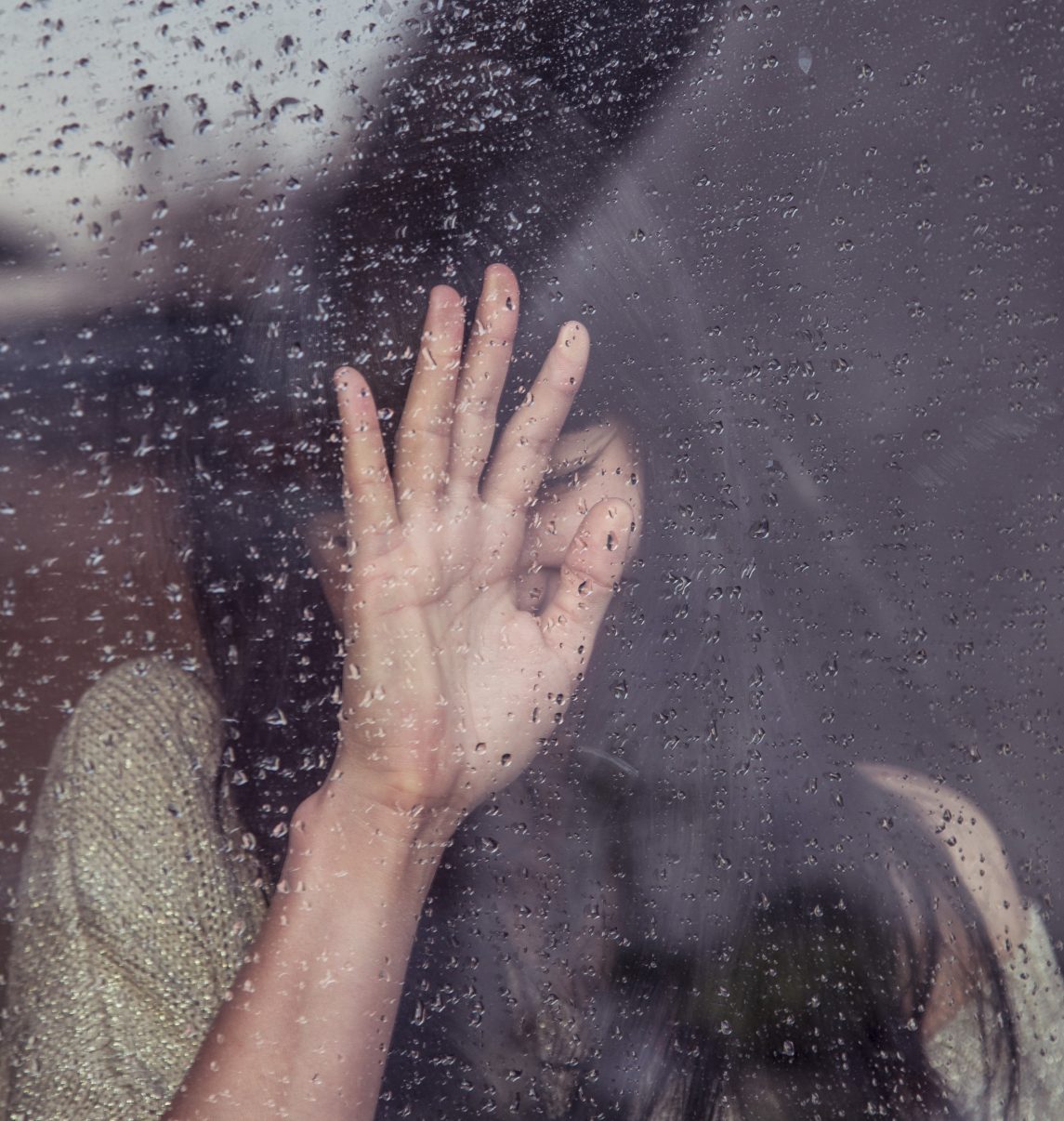 Woman devastated over a rainy window